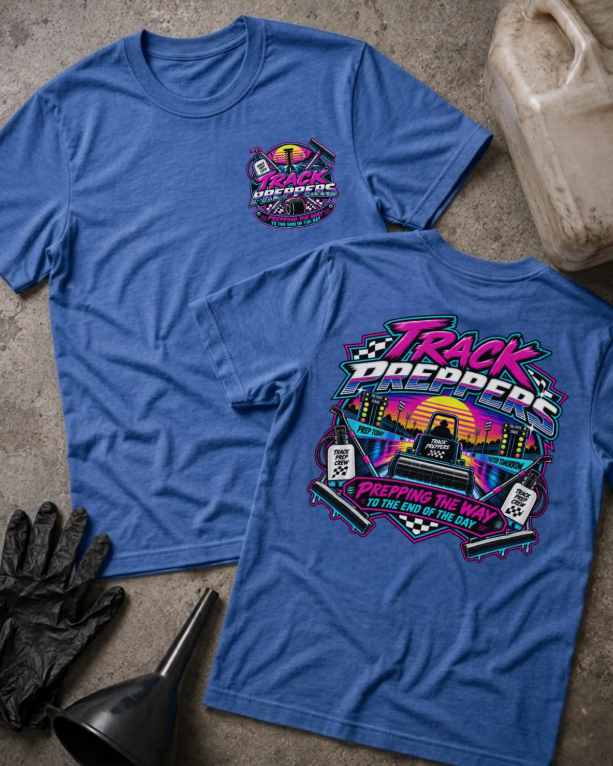 Front and back of Track Preppers heather true royal T-shirt with chest logo, track preparation equipment against a neon sunset, and “Prepping the way to the end of the day” slogan.