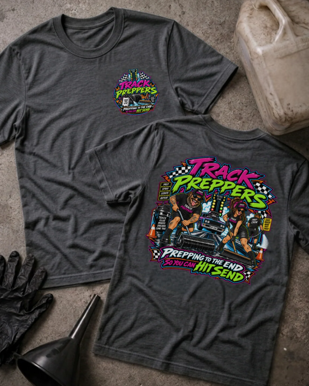 Front and back of Track Preppers dark grey heather T-shirt with chest logo, crew preparing a drag strip beside staging lights, and “Prepping to the end so you can hit send” slogan.