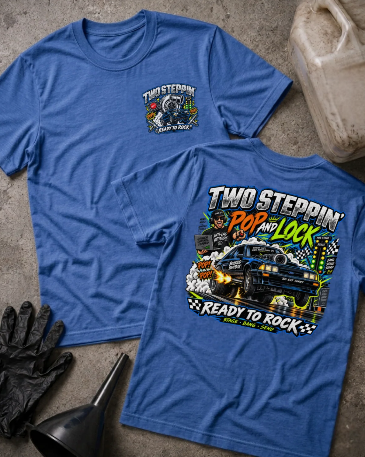 Front and back of Two-Step Pop and Lock heather true royal T-shirt with chest logo, blue drag car launching amid smoke and flames, and “Two Steppin’ Pop and Lock, Ready to Rock” text.