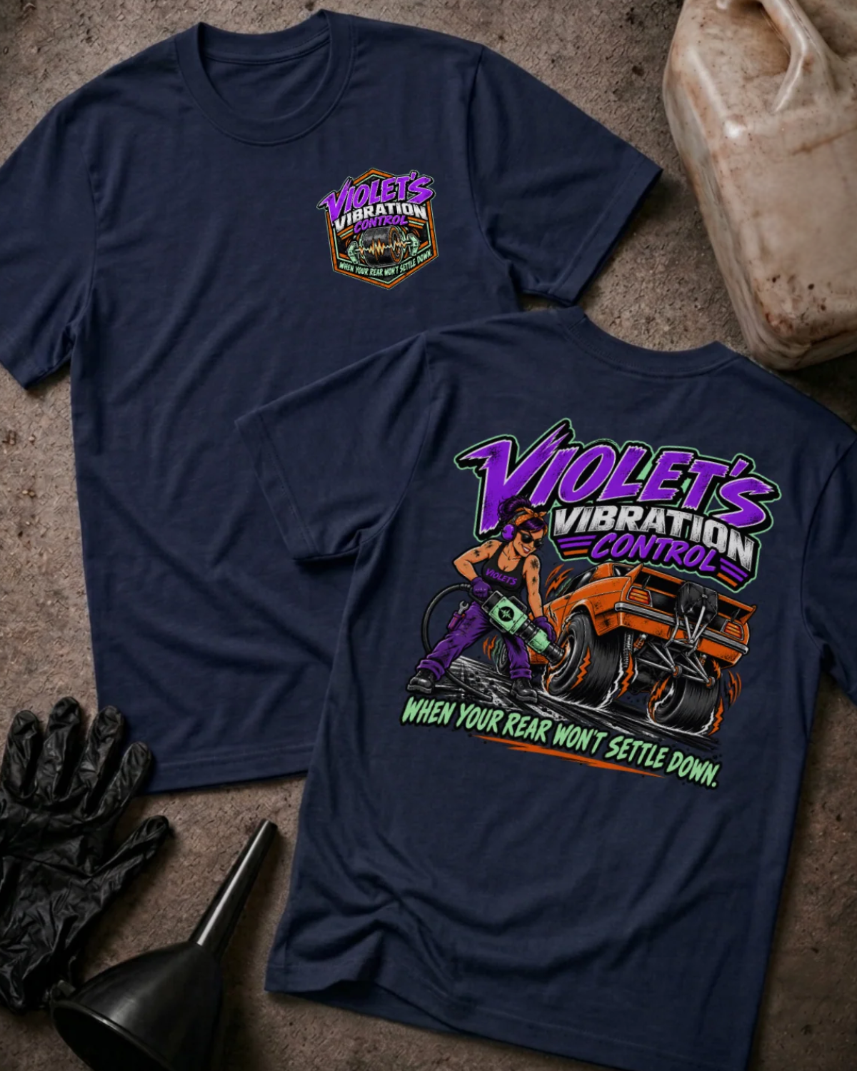 Front and back of Violet’s Vibration Control navy T-shirt with chest logo, woman holding a power tool beside an orange drag car, and “When your rear won’t settle down” slogan.