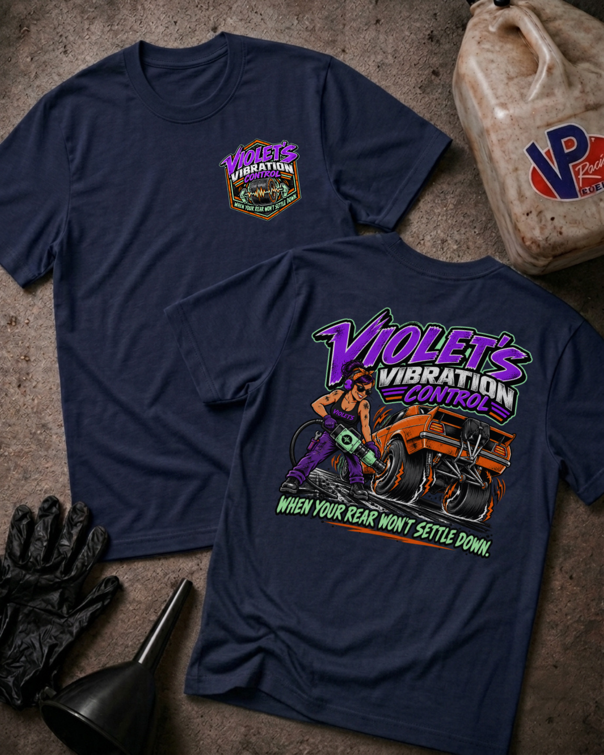 Two navy graphic t-shirts showing a 'VIOLET'S VIBRATION CONTROL' logo on the front and a colorful graphic of a woman and a racecar with 'VIOLET'S VIBRATION CONTROL WHEN YOUR REAR WON'T SETTLE DOWN' text on the back
