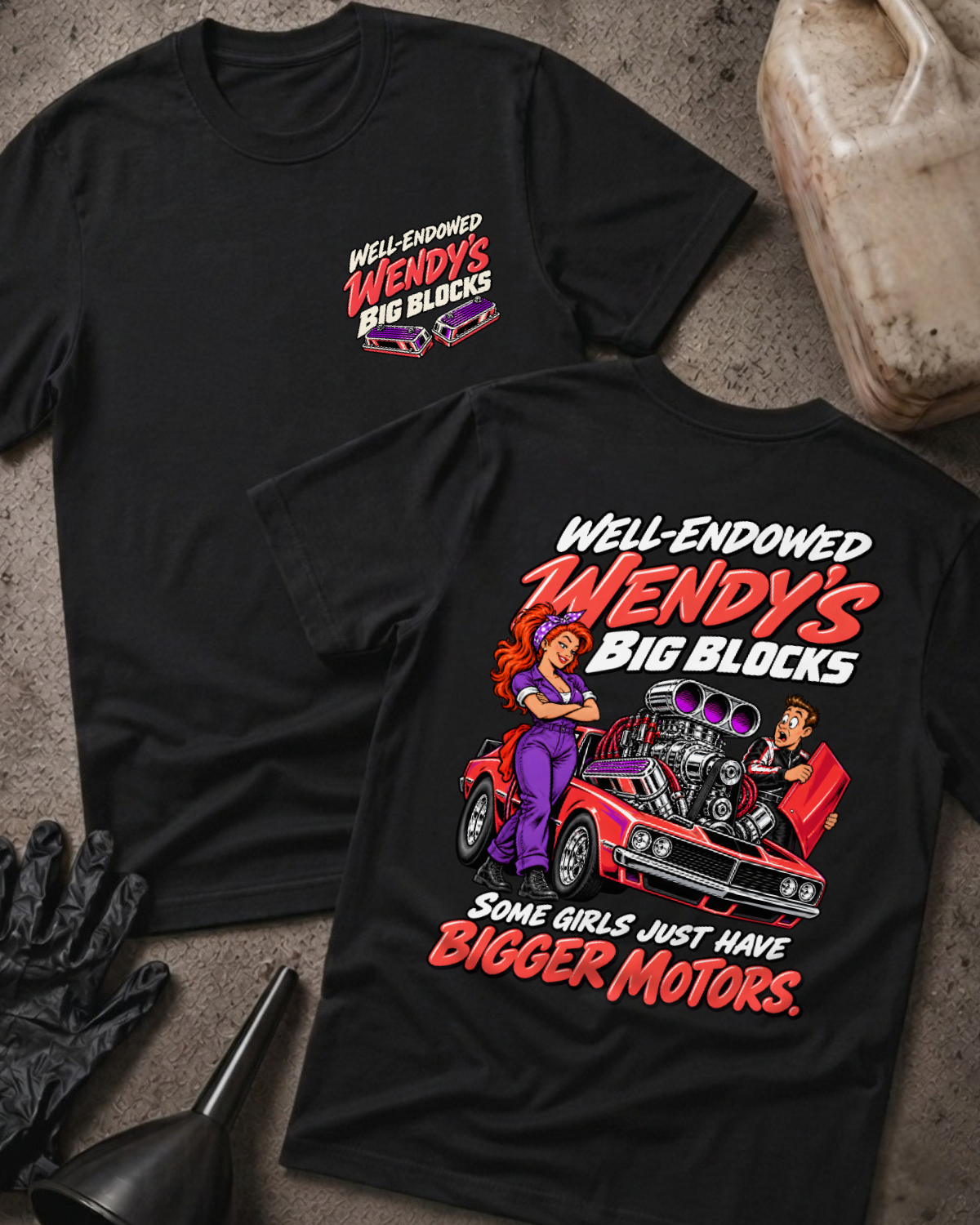 Black Well Endowed Wendy’s Big Blocks T-shirt showing the front chest logo and back cartoon of a woman mechanic by a red muscle car with a big supercharged engine, “Some Girls Just Have Bigger Motors,” with gloves, funnel, and oil jug props.