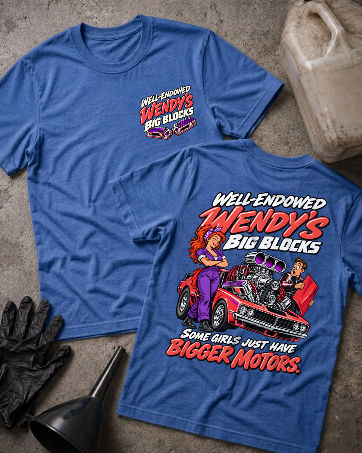 Heather royal blue Well Endowed Wendy’s Big Blocks T-shirt showing the front chest logo and back cartoon of a woman mechanic by a red muscle car with a big supercharged engine, “Some Girls Just Have Bigger Motors,” with gloves, funnel, and oil jug props.