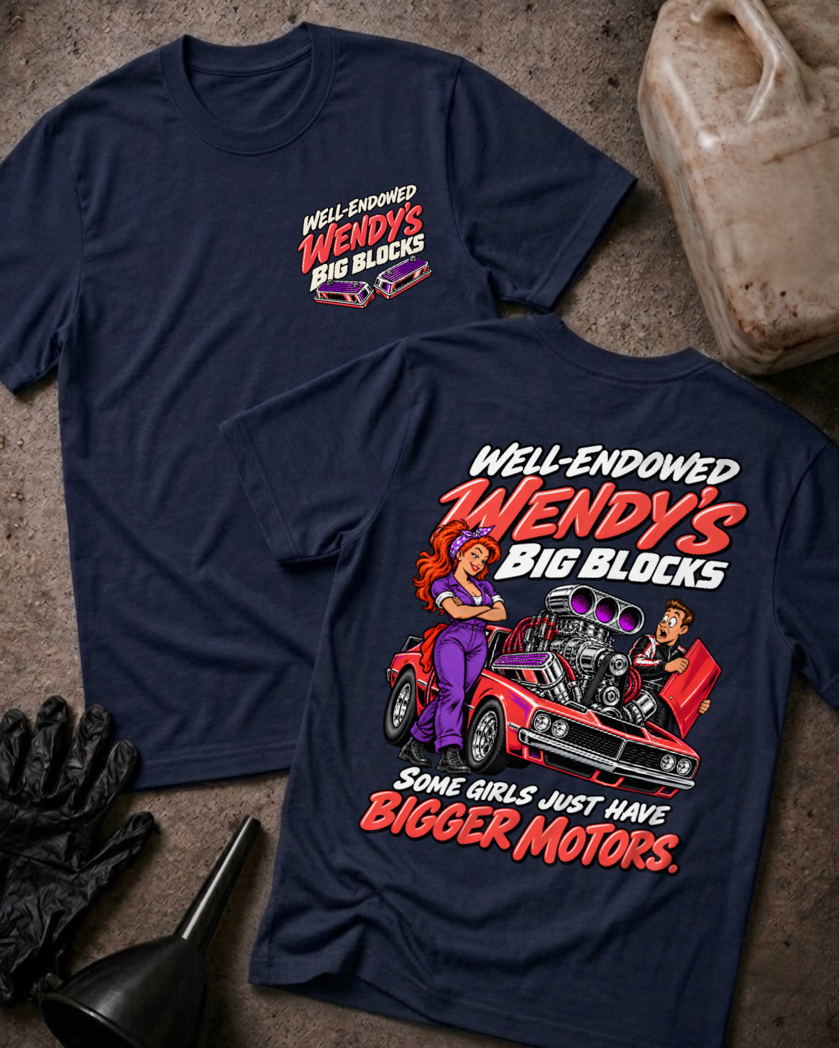 Navy Well Endowed Wendy’s Big Blocks T-shirt showing the front chest logo and back cartoon of a woman mechanic by a red muscle car with a big supercharged engine, “Some Girls Just Have Bigger Motors,” with gloves, funnel, and oil jug props.