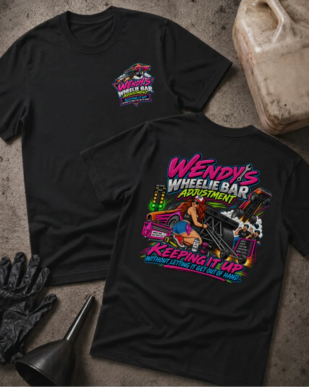 Front and back of Wendy’s Wheelie Bar Adjustment black T-shirt with chest logo, woman adjusting wheelie bars, and “Keeping it up without letting it get out of hand” slogan.