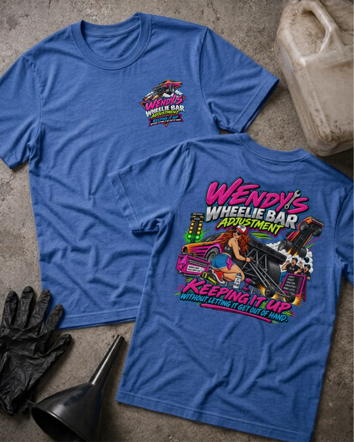Front and back of Wendy’s Wheelie Bar Adjustment heather true royal T-shirt with chest logo, woman adjusting wheelie bars, and “Keeping it up without letting it get out of hand” slogan.