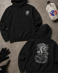 Two black hoodies are arranged on a concrete floor, showing both the front and back designs. The front hoodie features a small white graphic on the left chest, while the back hoodie features a large white graphic with the text 'WHISTLING DESTRUCTION' and a cartoon character.