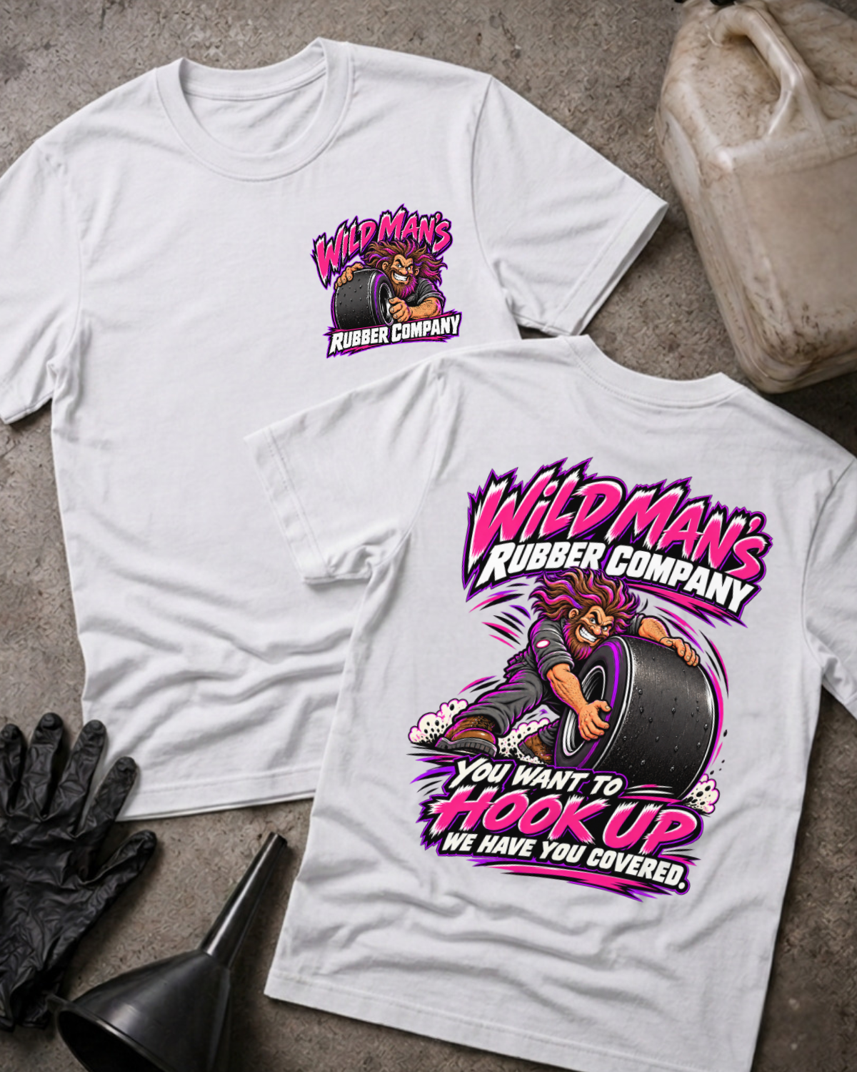 White Wild Man's Rubber Company T-shirt, front and back views with pink-and-white graphics of a man gripping a racing slick and “You want to hook up, we have you covered” slogan.