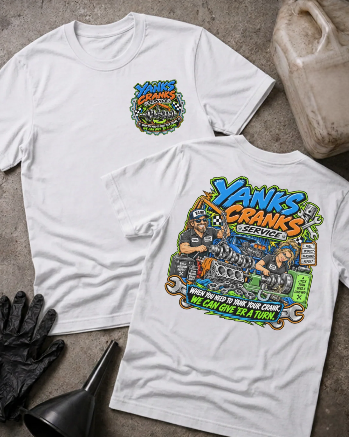Front and back of Yank’s Cranks Service white T-shirt with chest logo, two mechanics working on crankshafts, and “When you need to yank your crank, we can give ’er a turn” slogan.